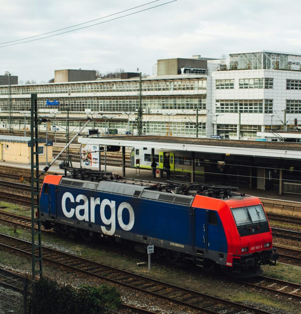 Red And Blue Train On Railroads